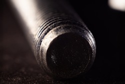 A closeup shot of a nail, drill screw end