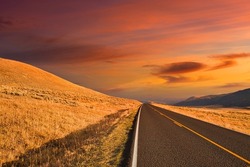 A mesmerizing view of empty asphalt road during a breathtaking sunset