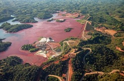 Aerial of a mine tailings reservoir in Magadascar, receiving slurry through a pipeline from an ore processing plant 