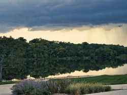 A large thunderstorm forming at Lake Olathe over the forest in Olathe city, Kansas
