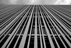 A grayscale of a high rise modern building exterior