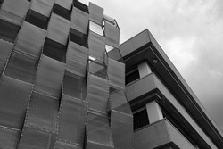 A grayscale of a high rise modern building exterior