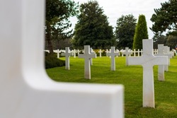 American cemetery at Omaha Beach, looking at the white grave crosses and an out of focus cross in the foreground