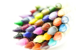 A closeup shot of colorful crayons on the white background