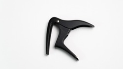 A closeup shot of a guitar fret capo isolated on a white background