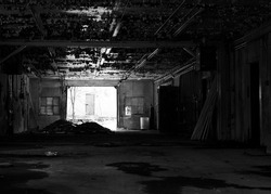 A greyscale shot of an abandoned building