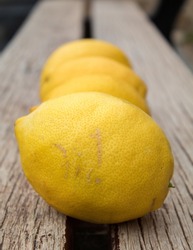 A shallow focus of lemons on a wooden table