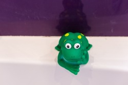 A closeup shot of a plastic bath frog to