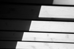 A grayscale closeup of Light and Shadow on stairs with a pattern