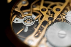 A closeup detail of the internal mechanism of a vintage analog clockwork