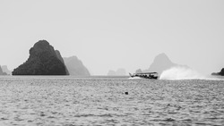 A grayscale shot of a boat ride in the sea, Ao Phang Nga National Park, Thailand