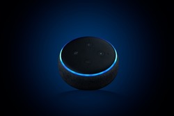 A closeup of an Echo Dot, Voice assistant on dark blue background