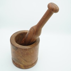 A wooden mortar and pestle on a white background