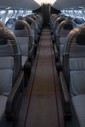 A vertical shot of the empty airplane aisle 