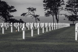 White grave crosses at the American cemetery in Normandy  view of the sea,  minimal black