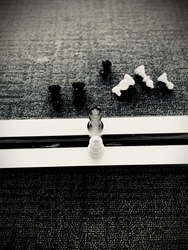 A vertical shot of black and white chess king figurines in front of each other - rivalry concept