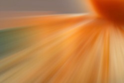 An orange starburst with dynamic sparkles with motion blur