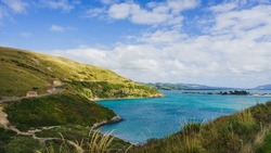 A beautiful view of Highcliffe Road along the ocean in Dunedin, South Island, New Zealand
