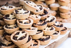 A closeup of Piles of delicious Christmas mince pies at Bath Christmas market