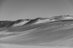 A grayscale shot of a beautiful mountainous landscape