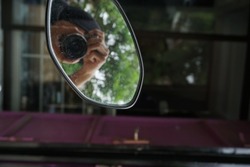 A closeup shot of a photographer doing selfie in auto mirror