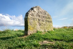 A close-up shot of Culloden battlefield memorial stone in Scotland