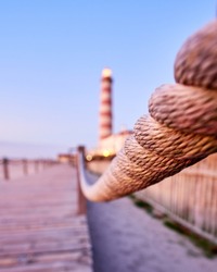 A selective focus of a rope of a walkway at sunset at the Barra beach, Aveiro, Portugal