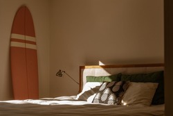 Bedroom with a Surfboard during golden hour