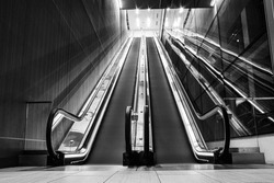 a grayscale shot of escalators