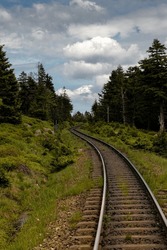 A scenic view of a picturesque Brocken landscape featuring a set of railroad tracks crossing through it