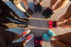 Top view of runners standing in a huddle with their feet together