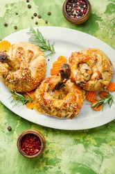 Chicken legs in pastry.Chicken leg in puff pastry on table