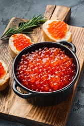 Canape toasts with red caviar, on gray background