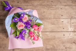 A beautiful bouquet of wedding flowers on old wooden boards. The concept for a holiday gift for Birthday, March 8 or Valentine's Day. Greeting card, a place for text, top view
