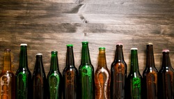 Beer bottles on a wooden table . Top view