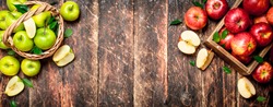 Red and green apples . On wooden background.