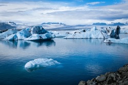 Big pieces of ice (floe) in water, ice islands, glacier and mountains, Jökulsárlón - Glacier Lagoon