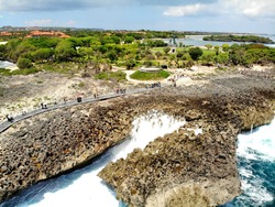 An amazing bird flight view on the Water Blow Nusa Dua. Tourist attraction has a natural phenomenon with waves crashing, towering up to 8 meters slammed in the reefs. Bali, Indonesia.