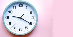 Analog white clock on a pink background. Clock in close up. Place for text. Business, are you ready.