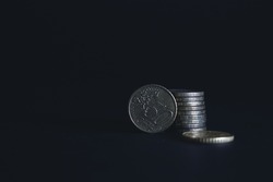 50 Euro cents on a black background. A fifty cent coin stands beautiful wallpaper money