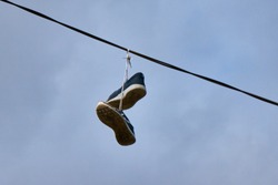 Shoes hanging on a cable