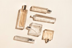 perfume bottles of beige color. Flatlay still life in the style of minimalism on a cream background, beauty and fashion