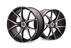 forged new alloy wheels on a white isolated background. cool sports wheels wheels with thin spokes auto tuning light weight, tire shop or motorsport design.