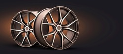 forged new alloy wheels on a dark black background. cool sports wheels wheels with thin spokes auto tuning light weight motorsport design panoramic photo copy space orange brown background