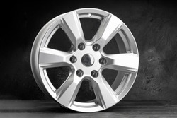 a new powerful six-spoke alloy wheel in silver color on a dark textured background. auto parts for SUVs and crossovers.