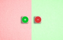 Juxtaposed red and green Plus and Minus icons on dice on a matching divided background in a concept of success and failure or positivity and negativity
