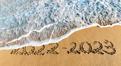 Year 2023 written in sand
