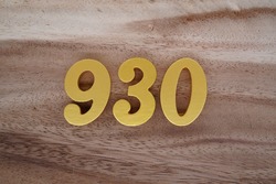 Gold numerals 930 on a dark brown to off-white wood pattern background.