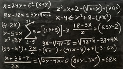 Mathematical operations written by hand with a chalk on the blackboard