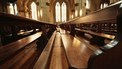 Catholic Cathedral Interior, Spiritual Design with Traditional Wooden Benches. Ancient Architecture and Benches, Details of Catholic Worship Space